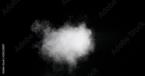 Real white mist isolated on black background with visible droplets