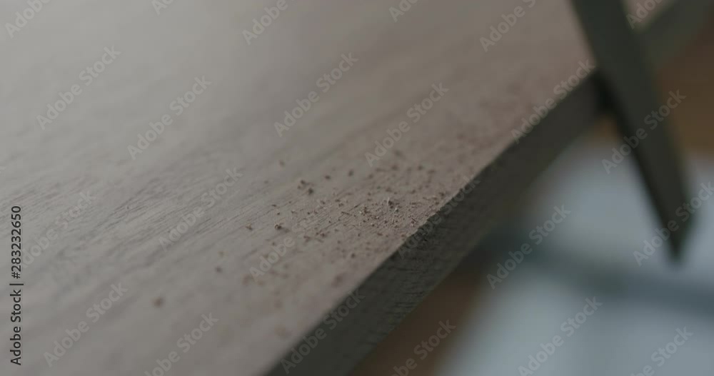 Slow motion woodworker hand sanding walnut board with file Slow motion woodworker hand sanding walnut board with file