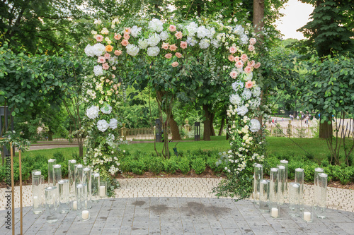 Wedding arch for ceremony outdoor with flower decoration and rustic design © Oleksandr Kozak
