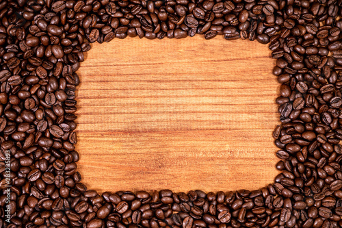 A coffee beans over wooden table top background.