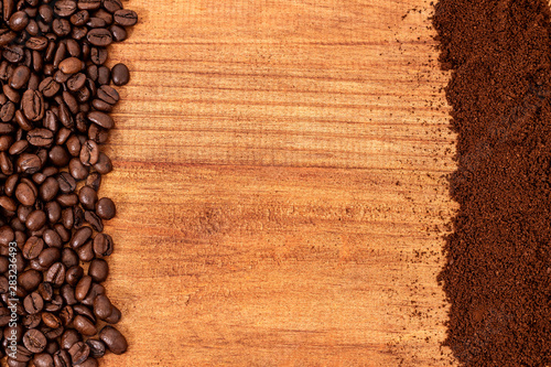 whole coffee beans and grounded coffee over a wooden table top background.