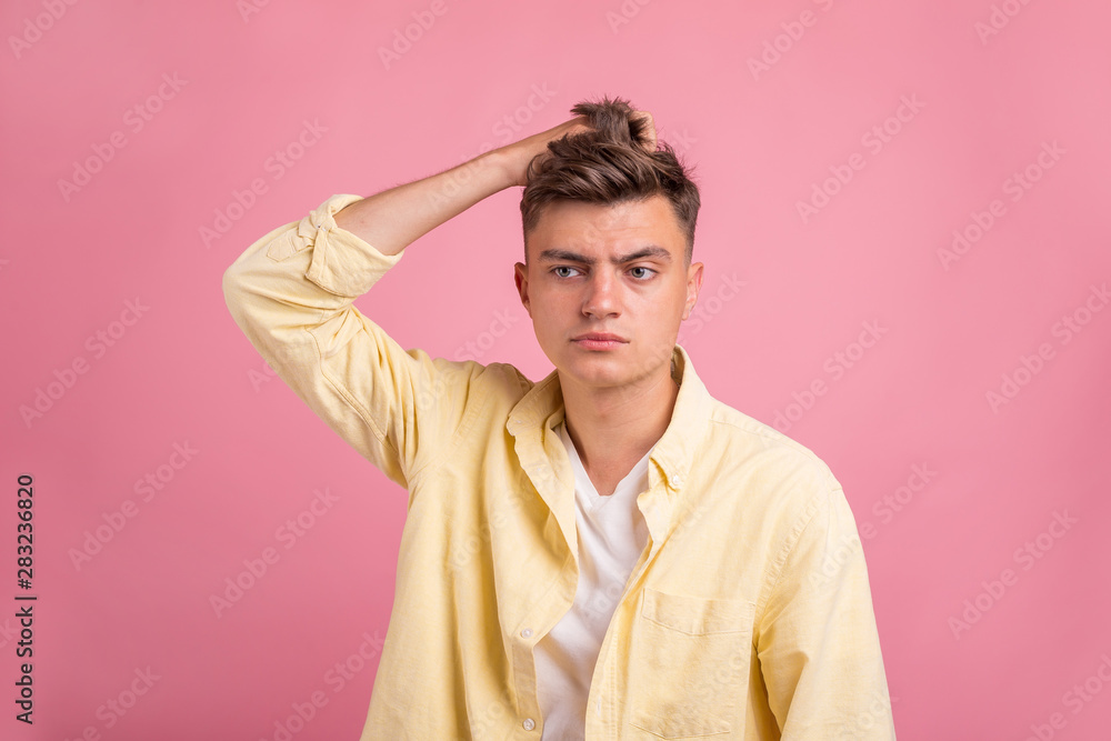 Portrait of young man with shocked facial expression on pink background Portrait of young man with shocked facial expression on pink background
