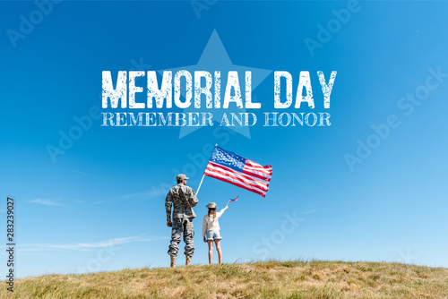 Принти на полотні Back view of kid in straw hat and military father holding American flags with me