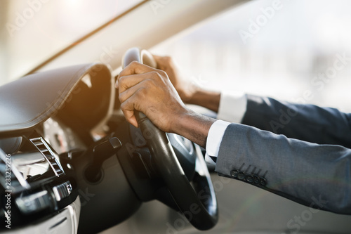 Afro businessman hands holding steering wheel, free space