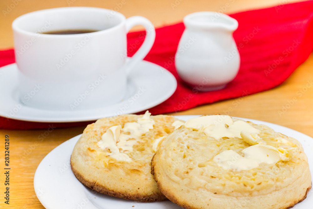English breakfast muffins with melted butter and tea and milk