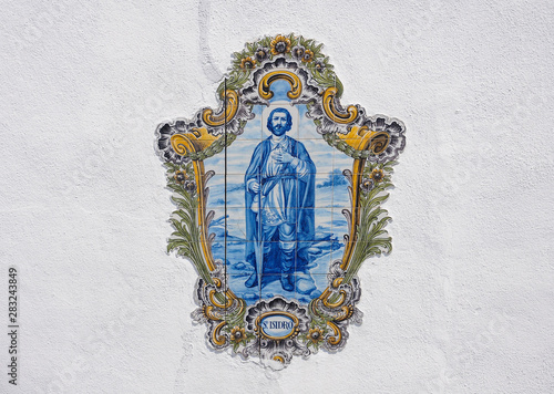 Saint Isidore, decorative ceramic tiles with blue and golden colors in Portugal photo