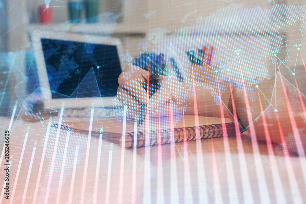 Financial graph displayed on woman's hand taking notes background. Concept of research. Double exposure Financial graph displayed on woman's hand taking notes background. Concept of research. Double exposure