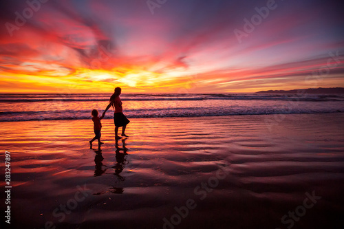 mother and son having fun at sunset on the beach © Maygutyak