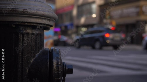Black American Fire Hydrant On An Iconic New York City Street As Classic Traffic Drives By