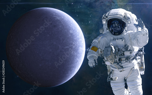 Fototapeta Naklejka Na Ścianę i Meble -  Mercury and astronaut. Solar system. Science fiction. Elements of this image furnished by NASA