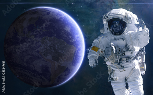 Fototapeta Naklejka Na Ścianę i Meble -  Earth and astronaut. Solar system. Science fiction. Elements of this image furnished by NASA