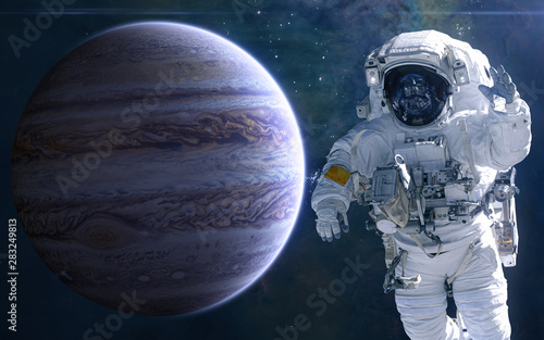 Jupiter and astronaut. Solar system. Science fiction. Elements of this image furnished by NASA