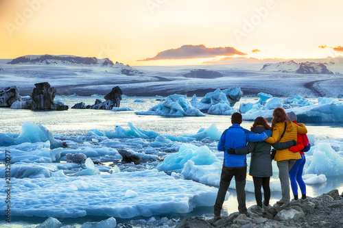 Group of tourist looking Beautifull landscape with floating icebergs in Jokulsarlon glacier lagoon at sunset photo