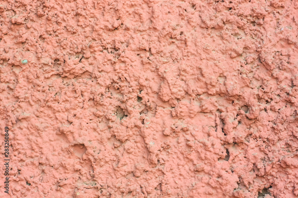 Vintage pink background. Texture of cement plaster. Rough painted wall of fiesta color. Copy space.