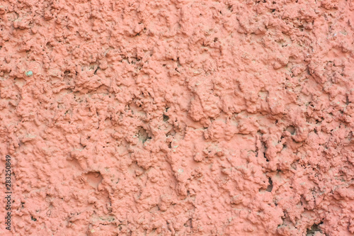 Vintage pink background. Texture of cement plaster. Rough painted wall of fiesta color. Copy space.
