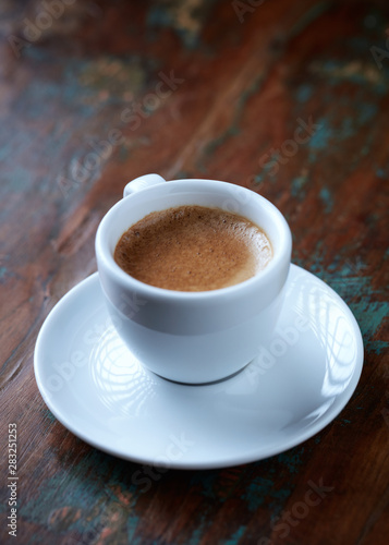 Cup of coffee on rustic wooden background. Copy space.