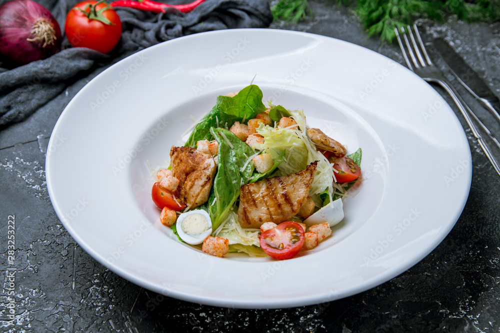 Salad caesar with chicken on grey concrete background Salad caesar with chicken on grey concrete background