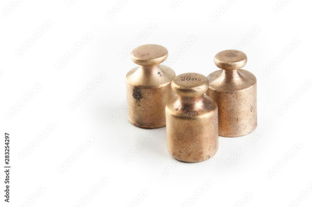 Antique bronze weights for scales on white background. Antique bronze weights for scales on white background.