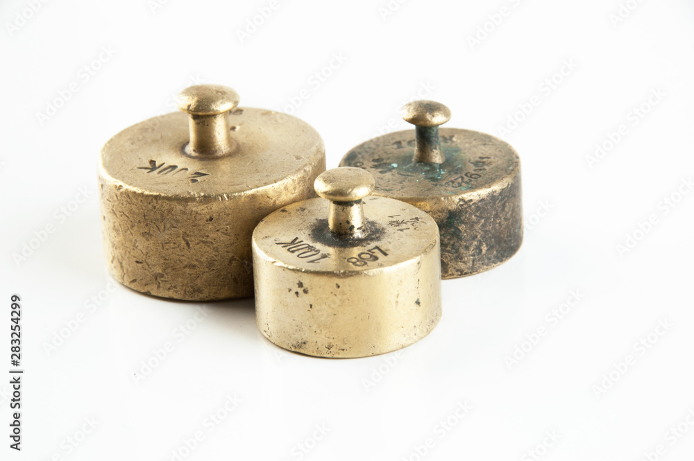 Antique bronze weights for scales on white background. Antique bronze weights for scales on white background.