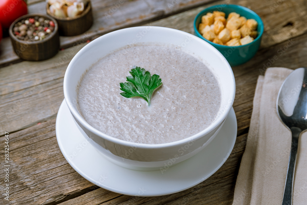 Cream soup of mushrooms on old wooden table Cream soup of mushrooms on old wooden table