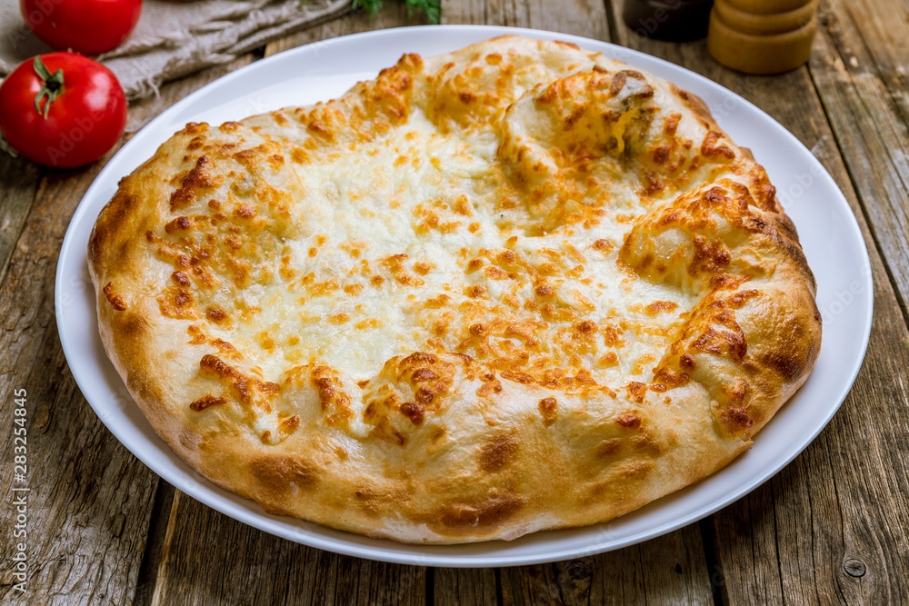 khachapuri with cheese on wooden table khachapuri with cheese on wooden table