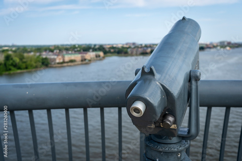 A telescope is mounted on a scenic vista along the Woodrow Wilson Bridge, overlooking the cities of Alexandria, Virginia and Washington, DC photo