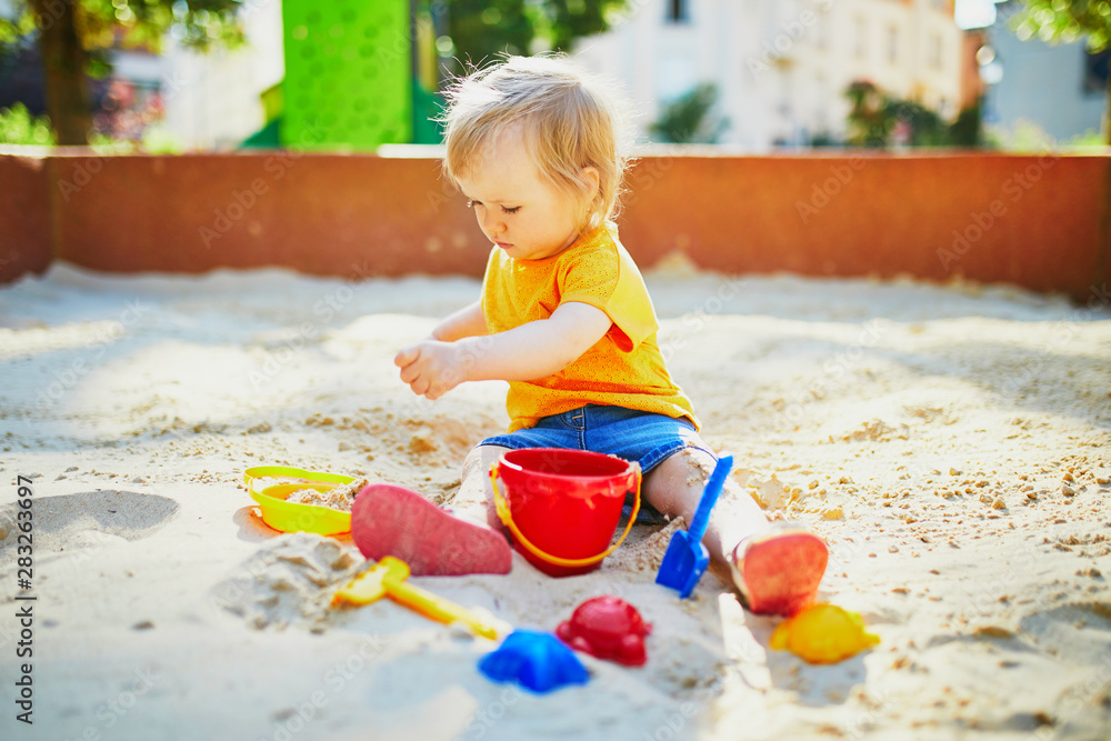 little girl having fun on playground in sandpit little girl having fun on playground in sandpit