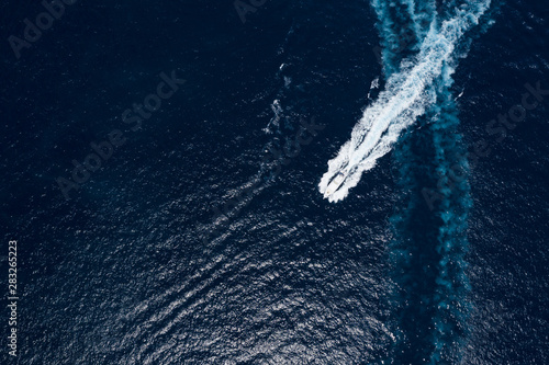 View from above  stunning aerial view of a luxury yacht sailing on a blue sea. Emerald Coast  Costa Smeralda  Sardinia  Italy.