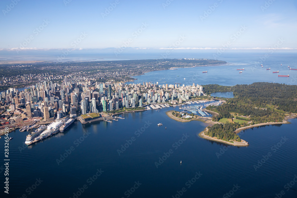 Aerial view of Downtown City, Port and Harbour in Vancouver, British Columbia, Canada. Taken during a sunny summer morning.
