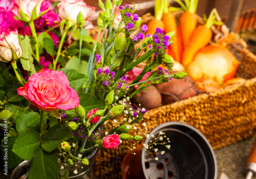 Obraz premium gardening with tools growing organic vegetables and flowers on the allotment for healthy eating and country living home grown food and flowers