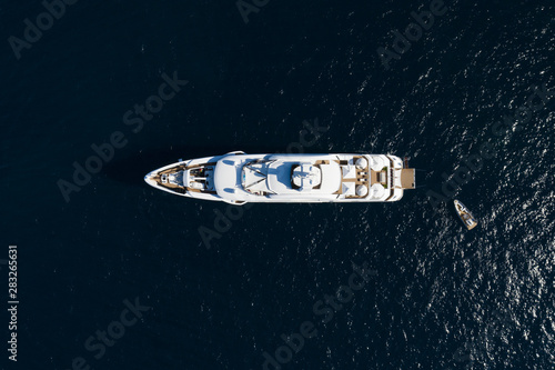 View from above, stunning aerial view of a luxury yacht sailing on a blue sea. Emerald Coast (Costa Smeralda) Sardinia, Italy.
