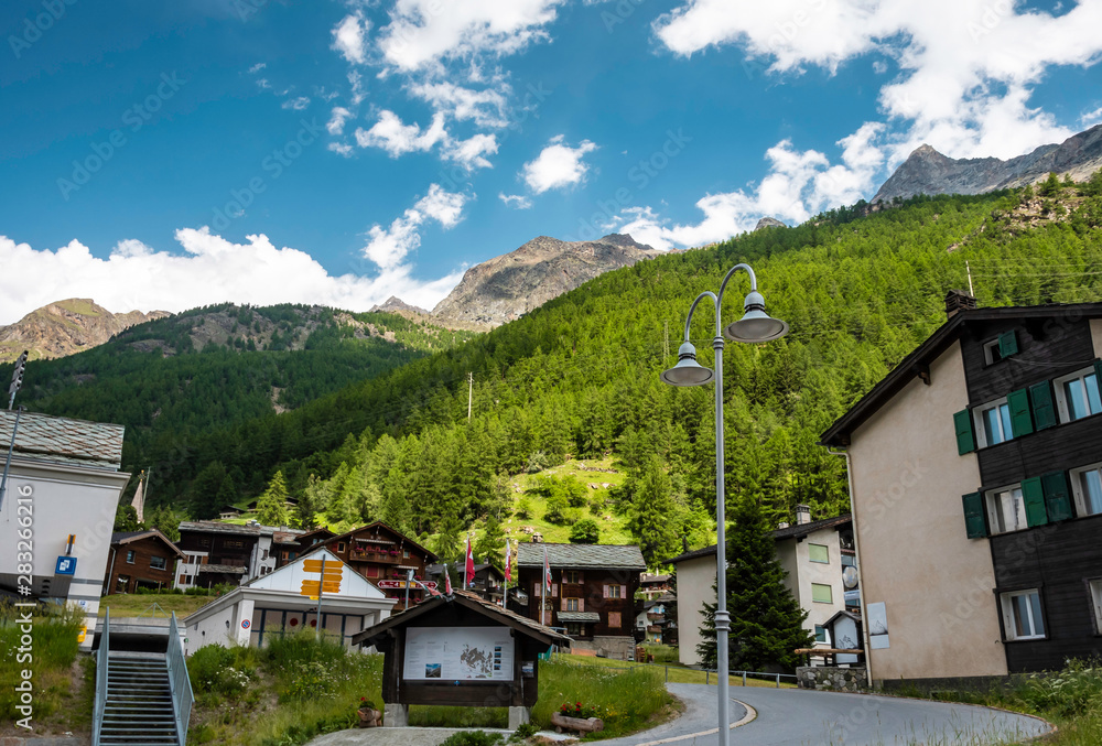 Typical Swiss Wooden chalets in canton of Valais, Switzerland in summer