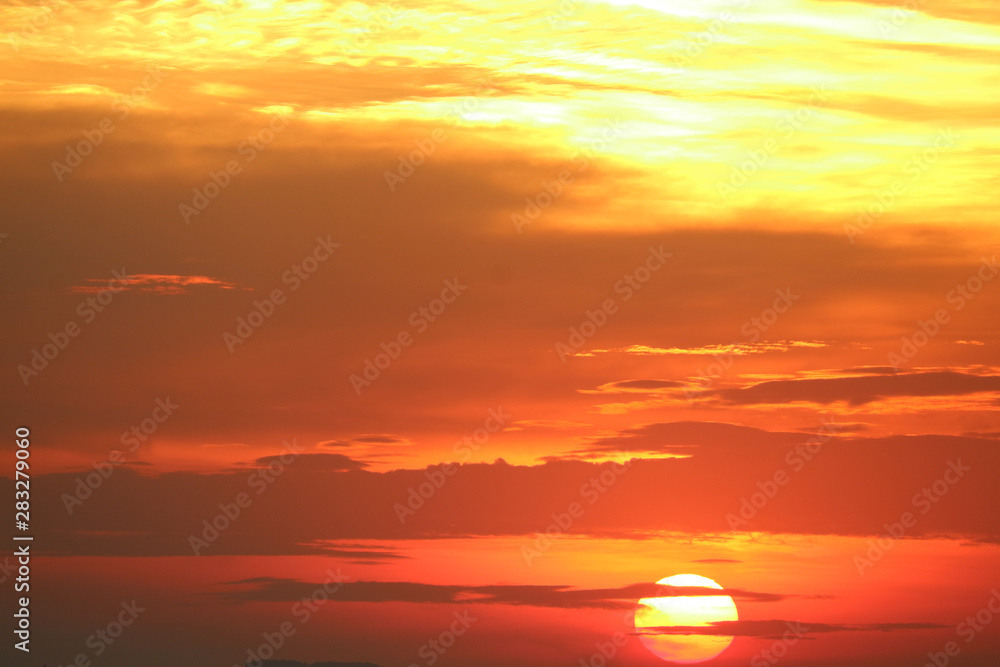 sunset on red orange sky back soft evening cloud over horizon sea