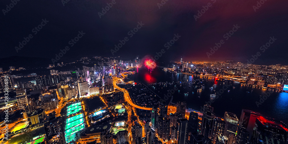 Panorama aerial view of Hong Kong City at night with fireworks
