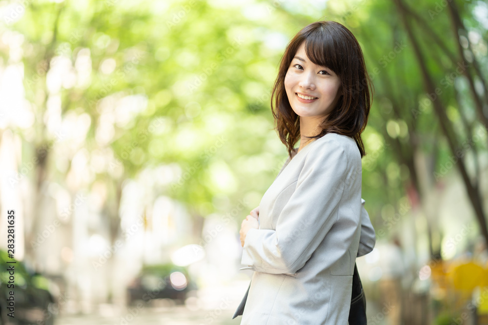portrait of asian businesswoman walking in sidewalk portrait of asian businesswoman walking in sidewalk