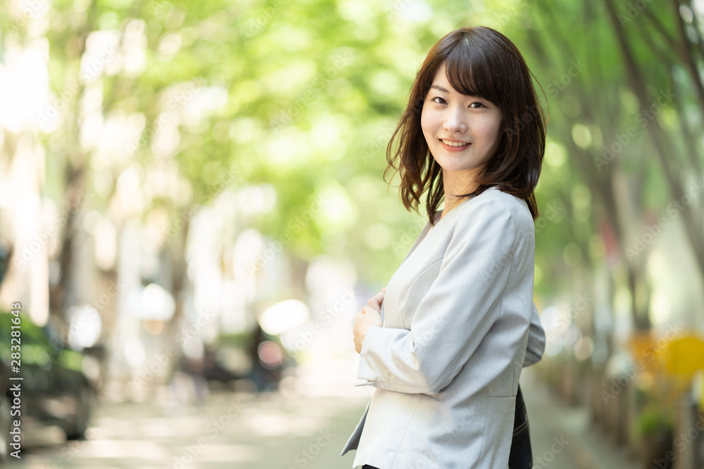 portrait of asian businesswoman walking in sidewalk portrait of asian businesswoman walking in sidewalk