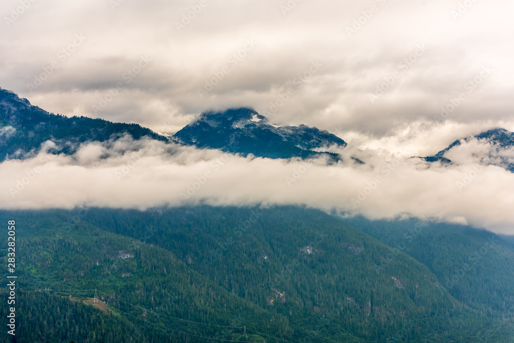 Aerial View at Mountains on Foggy and Misty Fall Morning in British Columbia, Canada. 
