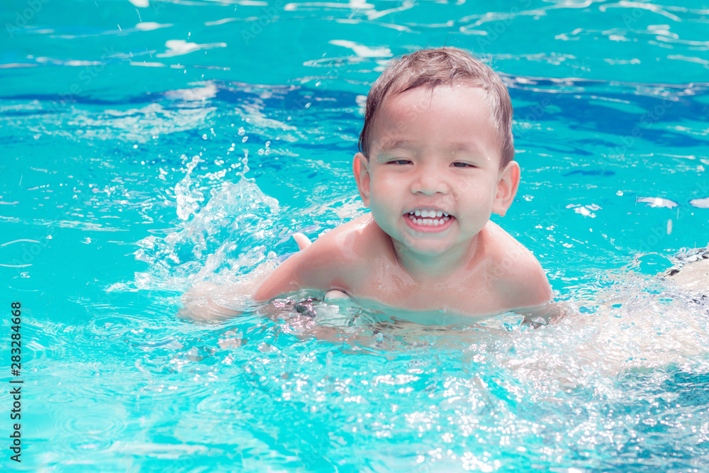  asian children having fun in a swimming pool at thailand