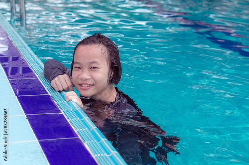 asian cute children girl in swimming pool at thailand