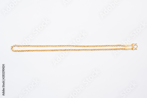 Gold chain necklace isolated on white background.