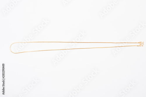 Gold chain necklace isolated on white background.