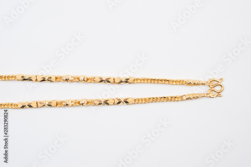 Gold chain necklace isolated on white background.