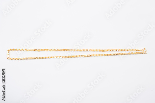 Gold chain necklace isolated on white background.