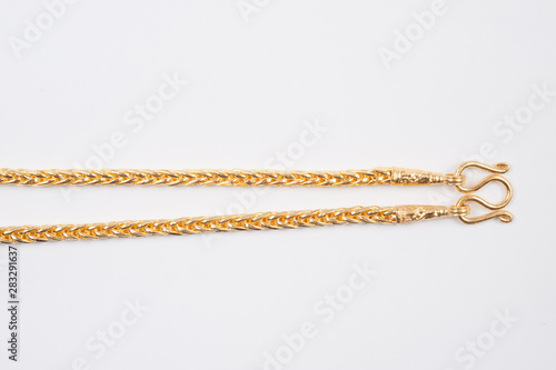 Gold chain necklace isolated on white background.