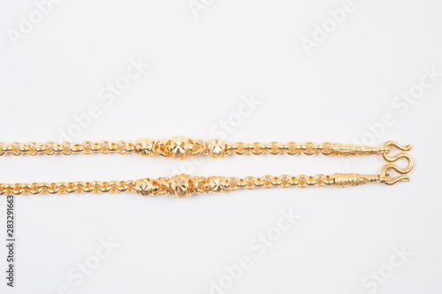 Gold chain necklace isolated on white background.