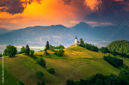 Alpine sunset landscape with Saint Primoz church, near Jamnik, Slovenia