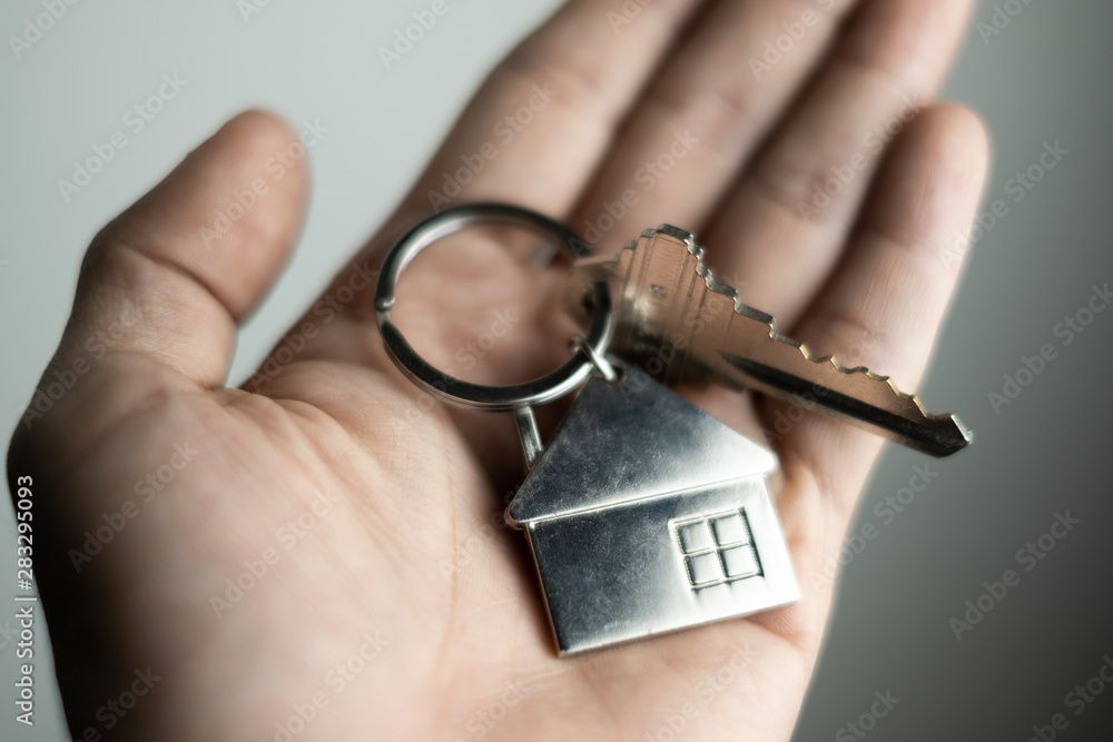 Obraz premium closeup key on human hand, personal loan concept. soft focus.