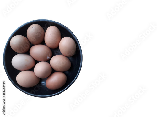Ten eggs in a black plate with fresh Arranged on the White Background to cook.