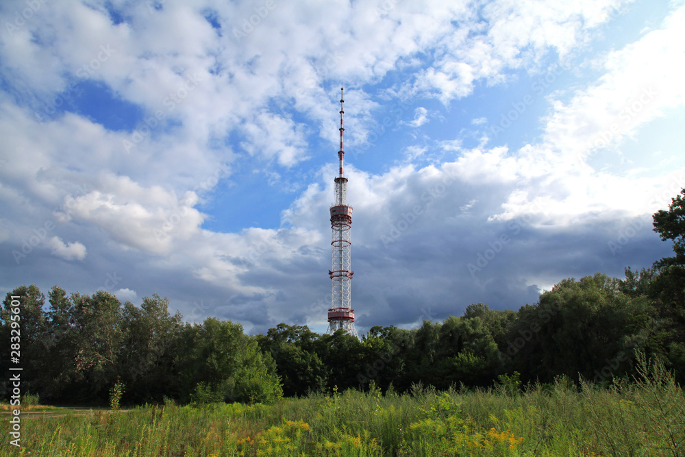 Kiev, Ukraine - July 18, 2019: TV Tower made of steel. The antenna of television centre in Kiev (Kyiv) under the blue sky with clouds