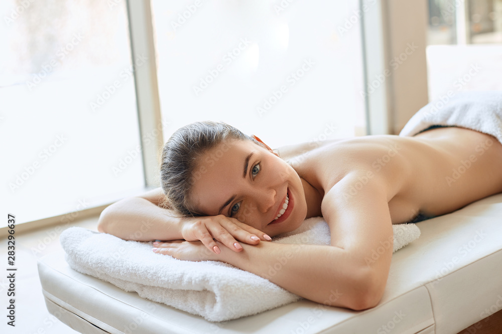 Portrait of young beautiful woman in spa environment. Body care. Spa body. Cosmetology. Massage Portrait of young beautiful woman in spa environment. Body care. Spa body. Cosmetology. Massage
